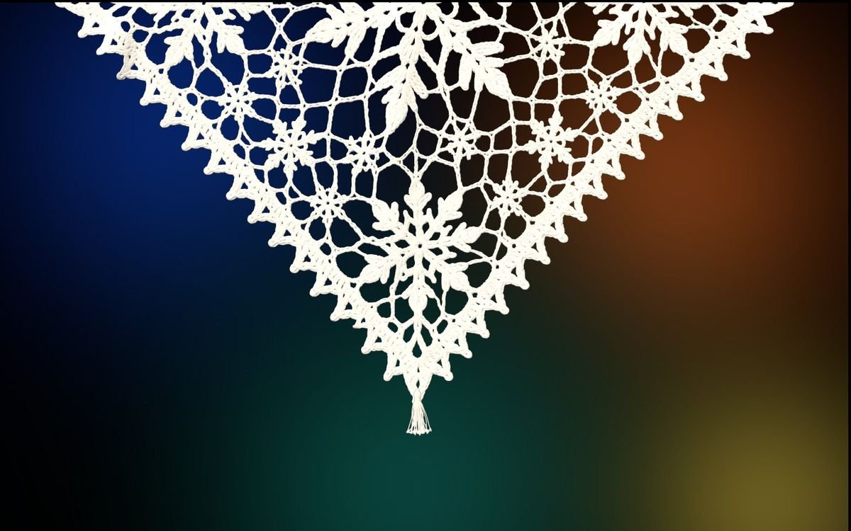 Snowflake lace in front of a dimmed, colourful desktop wallpaper